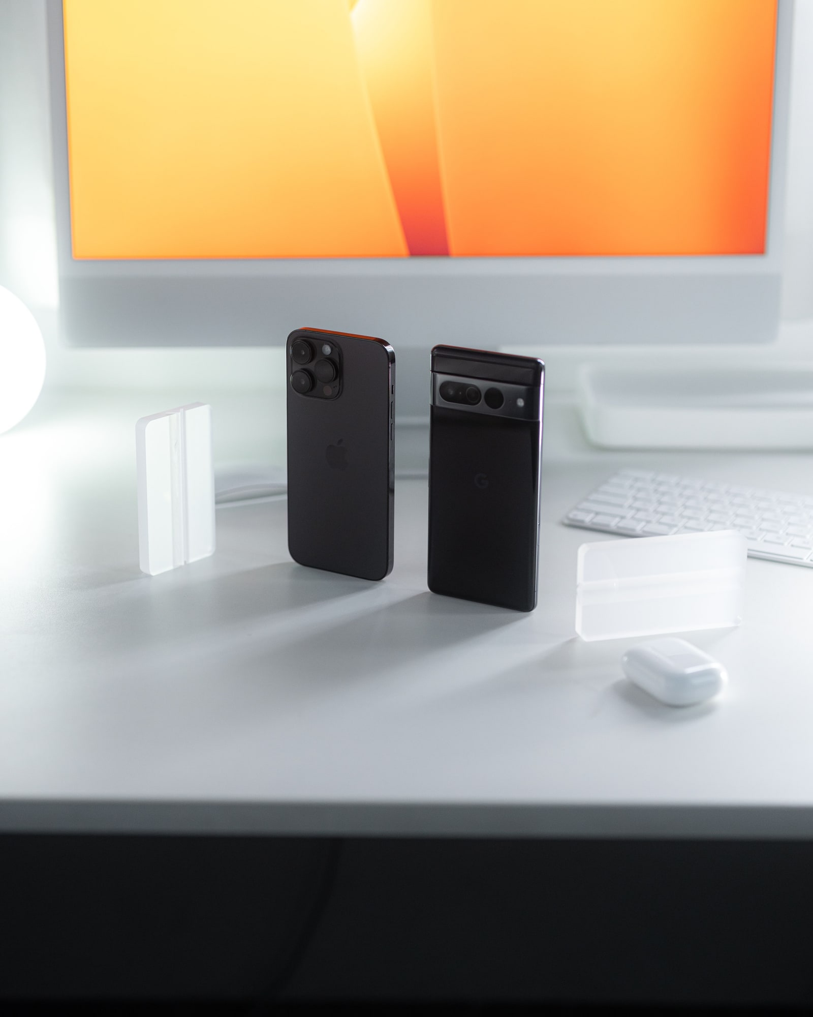 Two different smartphone models standing side by side for device comparison