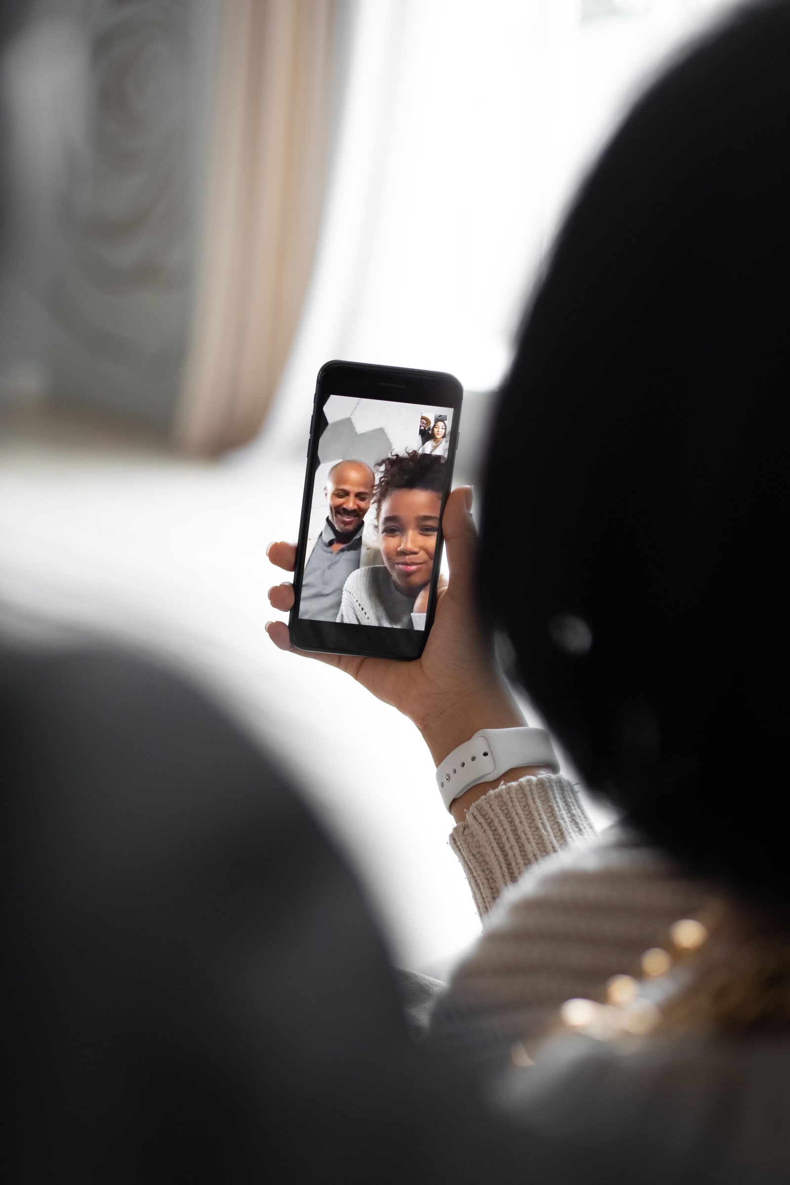 Person viewing a live video call on a smartphone